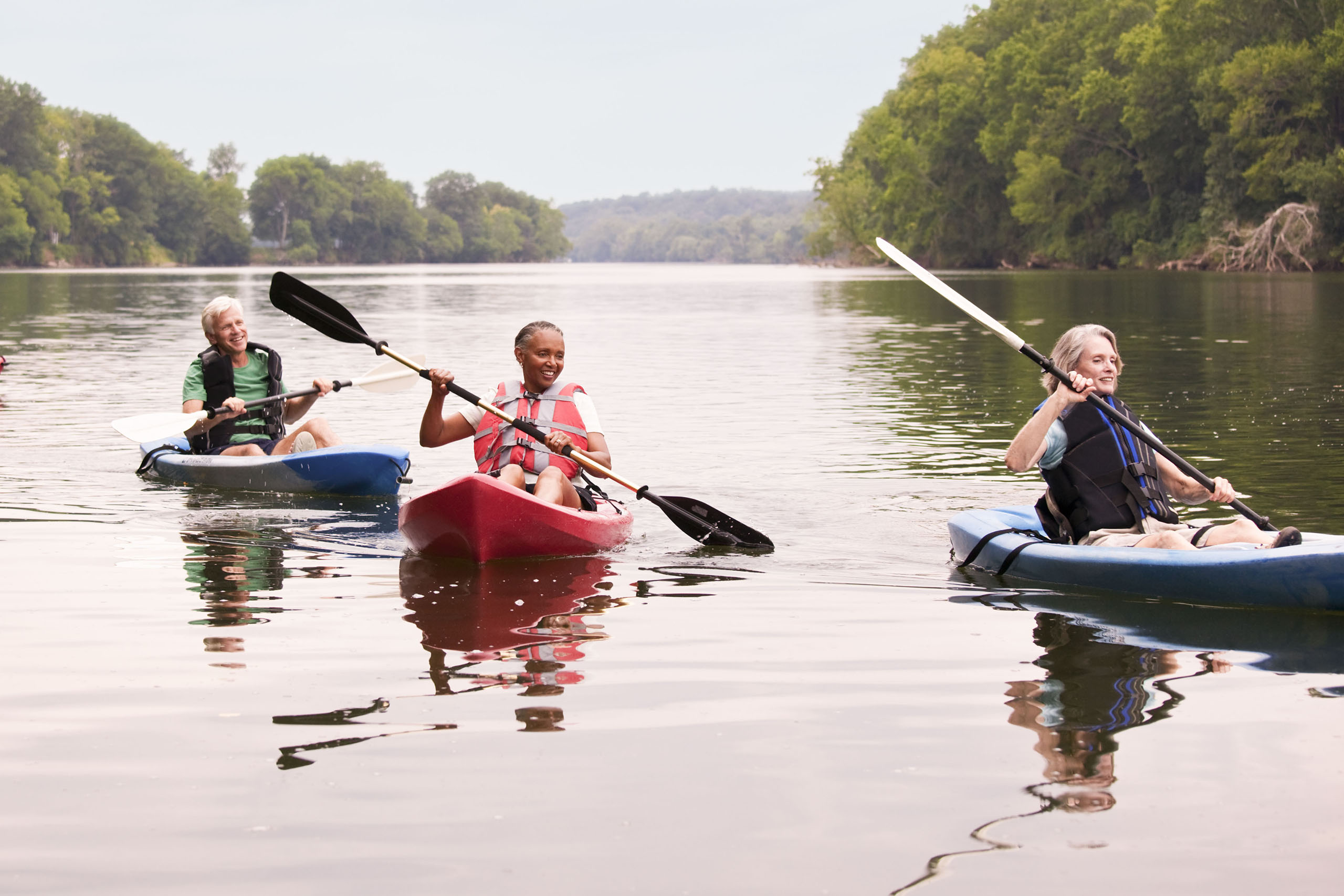 Couples kayaking on river