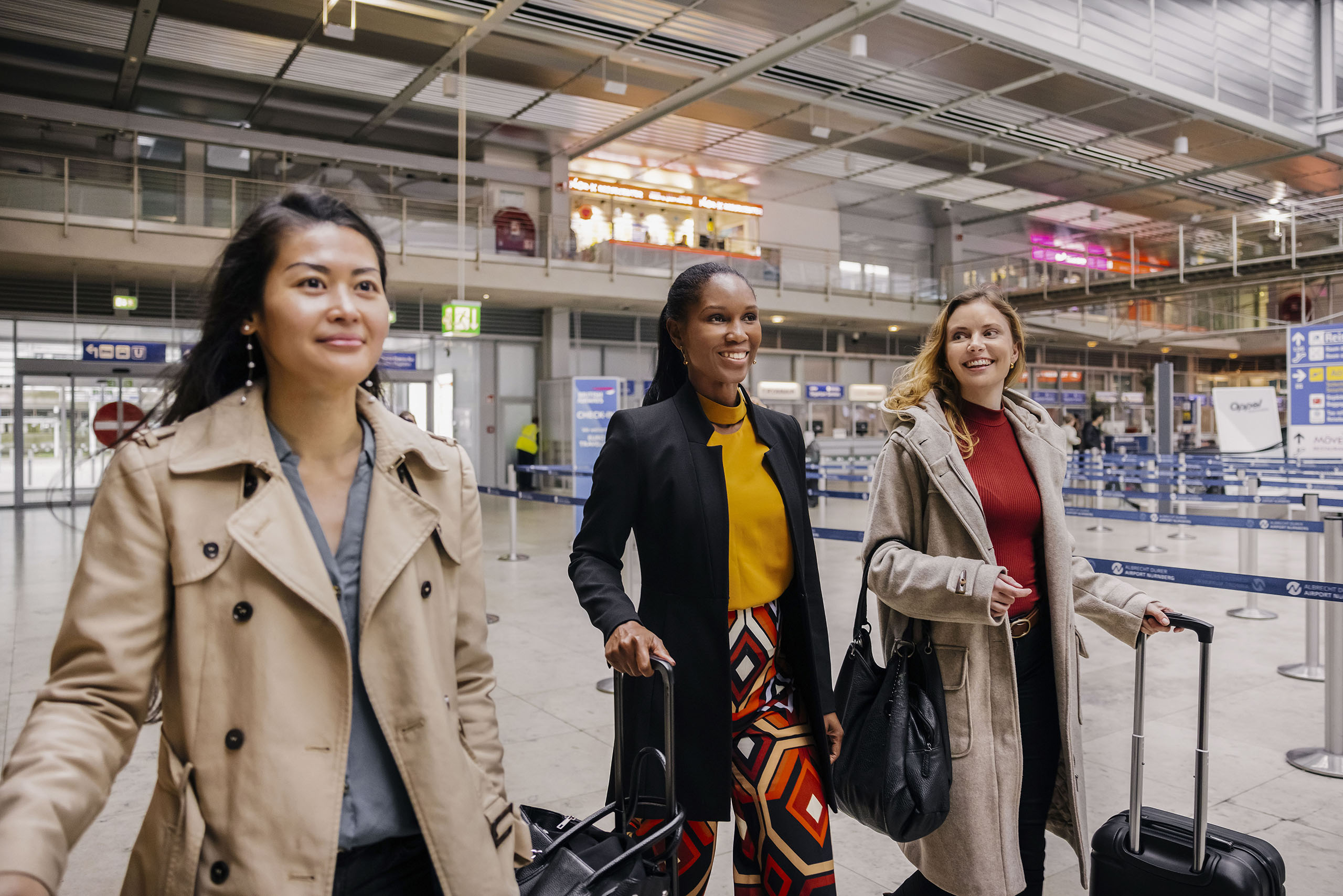 Three Friends Make Their Way Through An Airport Together