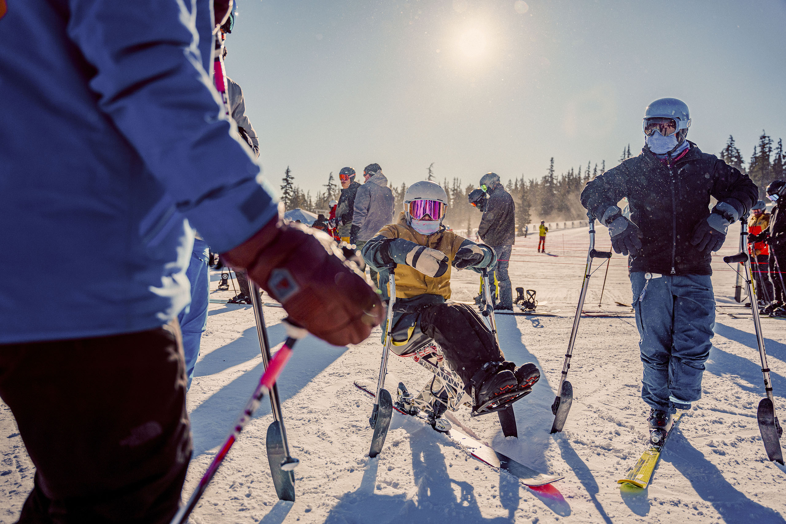 Friends spending time together between ski runs on sunny winter day